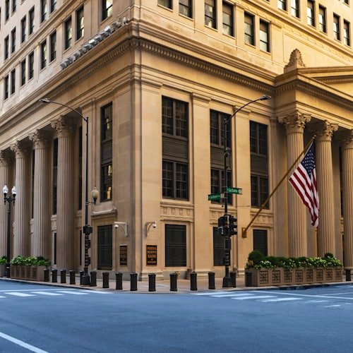 Federal Reserve building with columns and an American flag