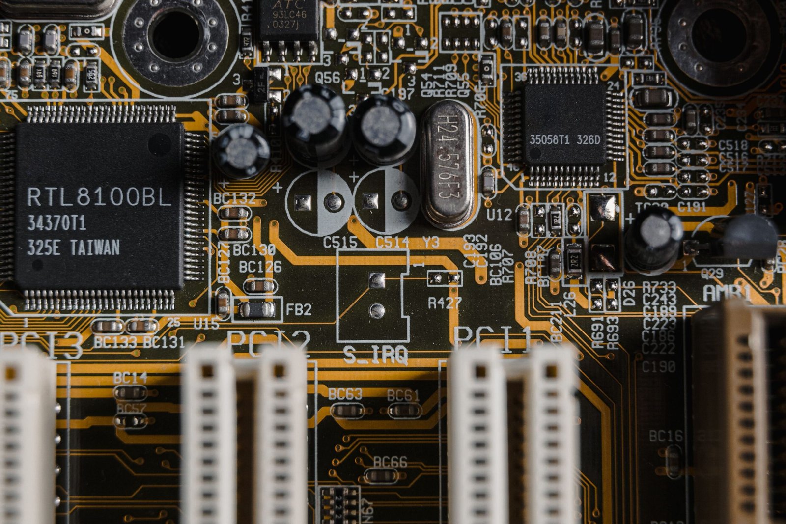 Close-up of a gold-plated computer motherboard with microchips
